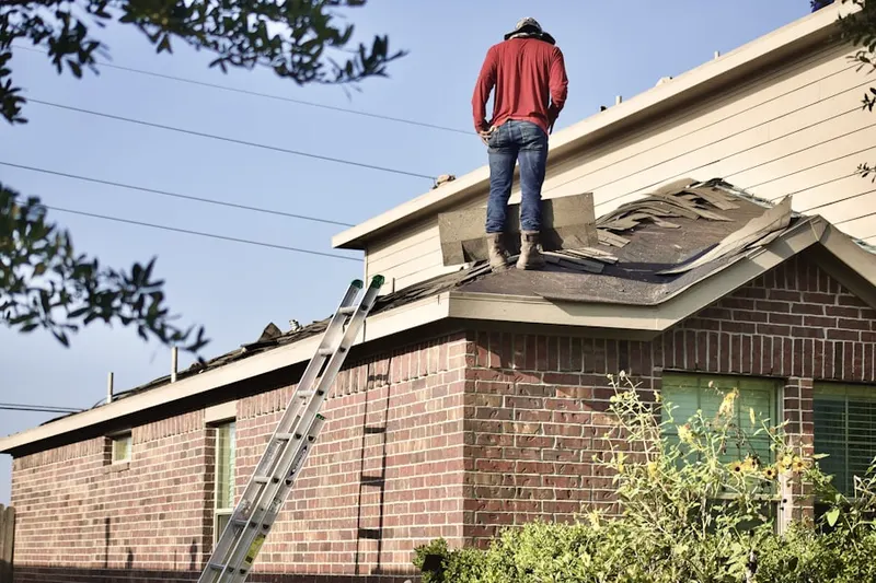 Professional roofer working on a residential roof in Brigadoon Village